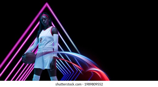 Beautiful African-american Female Basketball Player Posing With Ball In Neon Light On Dark Background. Concept Of Healthy Lifestyle, Professional Sport, Hobby. Woman In Sport.