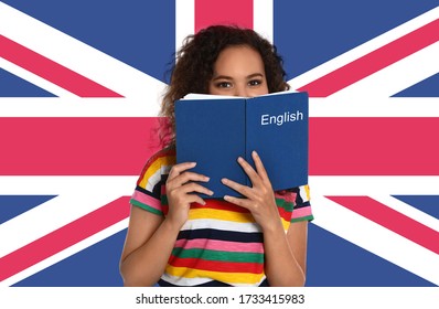 Beautiful African-American Girl With Book And Flag Of Great Britain As Background. Learning English