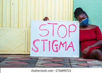 A Beautiful African/black Woman In Locally Made Mask, Looks Sad And Advocating On Avoidance Of Social Stigma Against People Infected With Corona Virus - Concept On Education On Stop Stigma Covid-19