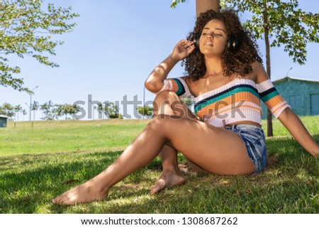 Similar – Brunette surfer woman in bikini standing with surfboard