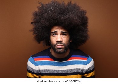 Beautiful afro man in front of a brown background - Shutterstock ID 615668255
