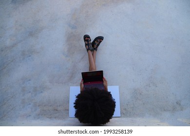 Beautiful Afro-american Woman Sitting With Her Laptop In A Park. The Photo Is Taken From Above And You Can See The Girl Below. Concept College Student