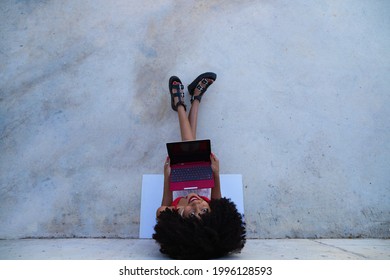 Beautiful Afro-american Woman Sitting With Her Laptop In A Park. The Photo Is Taken From Above And You Can See The Girl Below. Concept College Student