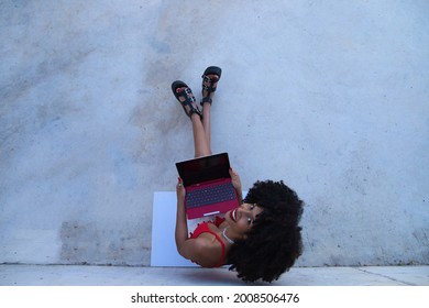 Beautiful Afro-american Woman Sitting With Her Laptop In A Park. The Photo Is Taken From Above And You Can See The Girl Below. Concept College Student