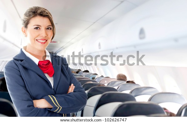 Beautiful air hostess\
in an airplane\
smiling