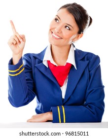 Beautiful Air Hostess Pointing With Her Finger - Isolated Over A White Background