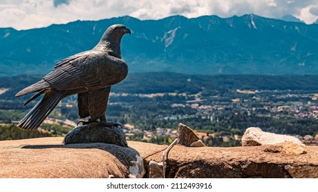Beautiful alpine summer view with details of a bird of prey statue at the famous Landskron castle ruins, Villach, Kaernten, Austria