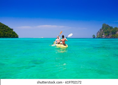 Beautiful amazing nature landscape. Tropical blue sun sea. Luxury resort. Island Phi Phi in Thailand. Tropical paradise. Inspiring holidays. Hot beach. Woman and man kayaking