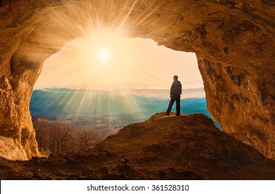 Beautiful amazing sunset.  Mountains in north country Russia Caucasus. Unique landscape mainsail.  Silhouette of a man. Old cave. Active sport and hobby. Spelunking background. Quest - Shutterstock ID 361528310