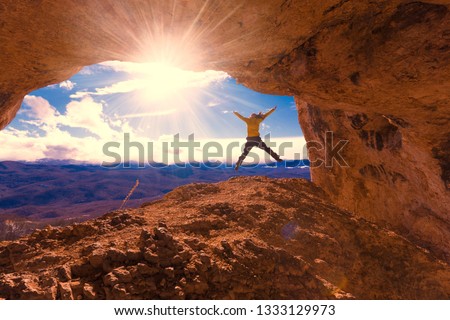 Beautiful amazing sunset.  Mountains in north country Russia Caucasus. Unique landscape mainsail.  Jumping travel woman. Old nature cave. Active sport hobby. Spelunking quest panorama.