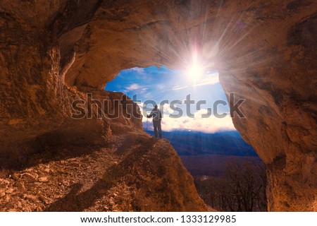 Beautiful amazing sunset.  Mountains in north country Russia Caucasus. Unique landscape mainsail.  Inspiring travel man. Old nature cave. Active sport hobby. Spelunking quest panorama.