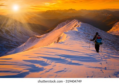 Beautiful amazing sunset winter mountains.  A man goes a sport hike in snow holidays. Christmas background. Unique landscape. Northern country Russia Caucasus. Quest - Shutterstock ID 319404749