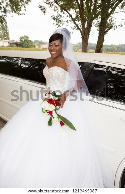 beautiful american african black bride in front of\
the wedding limo car