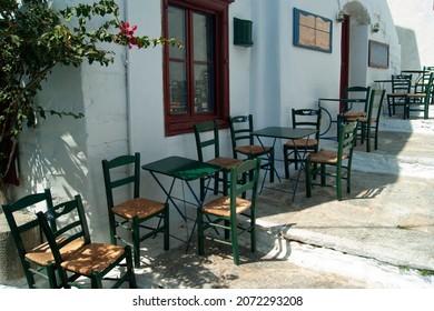 Beautiful Amorgos island, Greece Traditional taverna with shaded terrace Old fashioned tables and chairs  Landscape aspect shot