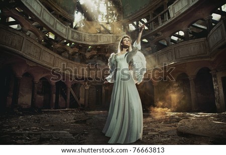 Beautiful angel in old, abandon place