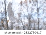 beautiful angel statue on cemetery, autumn nature background. Design for condolence, mourning card or obituary. symbol of religion, faith, mourn, memory. all saints day, All Souls Day