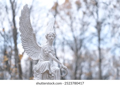 beautiful angel statue on cemetery, autumn nature background. Design for condolence, mourning card or obituary. symbol of religion, faith, mourn, memory. all saints day, All Souls Day - Powered by Shutterstock