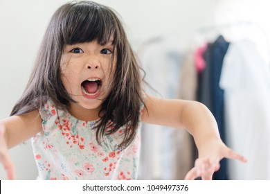 Beautiful Angry Little Girl Looking At Camera.Mad Kid Got Upset And Sad And She Has A Negative Attitude.Depressed Little Girl Complaining.