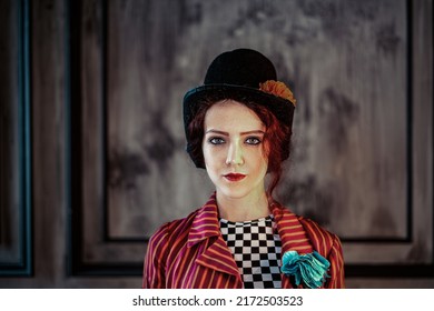 A beautiful animator or cabaret girl in a costume of a ringmaster (entertainer) of an old circus: a red striped tailcoat, a bowler hat, a large buttonhole on her chest. Vintage steampunk style