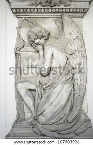 Beautiful antique angel statue kneeling, Staglieno, Genoa