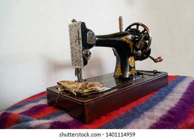 A Beautiful Antique Sewing Machine On A Mohair Blanket.