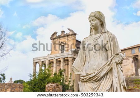Beautiful antique statue of Vestal Virgin.In the background Temple of Antoninus and Faustina ,adapted to  church of San Lorenzo in Miranda. Roman Forum ( Famous world landmark ). Rome. Italy. Europe.