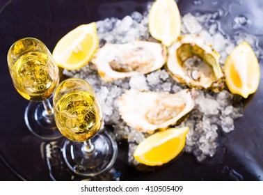 beautiful appetizer oysters and alcohol two glasses wine champagne luxury life background studio food.