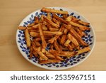 Beautiful appetizing homemade fries made from deep-fried potatoes, unhealthy food