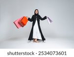 Beautiful arab middle-eastern woman with traditional abaya dress in studio - Arabic muslim adult female portrait in Dubai, United Arab Emirates