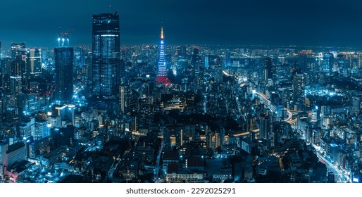 Beautiful architecture building cityscape and illuminated Tokyo Tower from the observation deck of Roppongi Hills at night in Tokyo, Japan