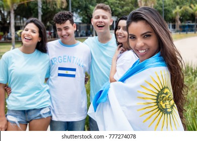 Beautiful argentinian sports fan with other supporters from Argentina