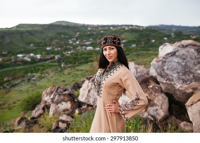 Beautiful Armenian woman in the national costume of Taraz on the background of the highlands