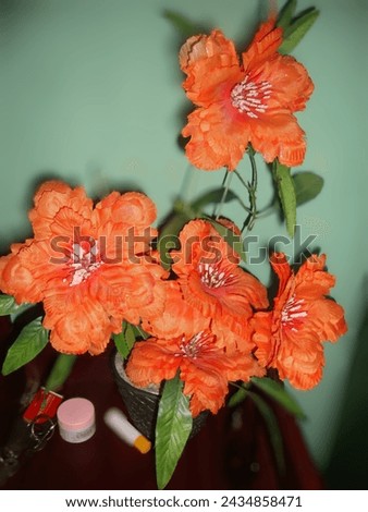 Beautiful  artificial orange flowers with green background 