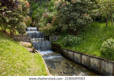 Beautiful artificial waterfall with several falls. Water running freely due to the action of gravity.