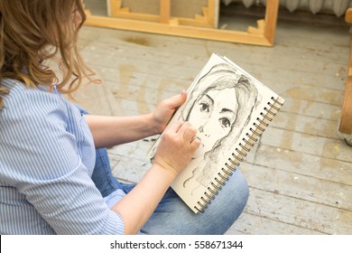beautiful artist paints the portrait in the art Studio