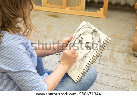 beautiful artist paints the portrait in the art Studio