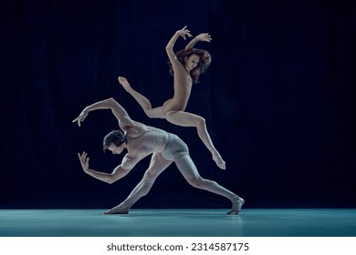 Beautiful, artistic, young couple, man and woman dancing ballet against blue studio background. Impressive art. Concept of beauty, classical dance style, inspiration, movements. Ad - Powered by Shutterstock