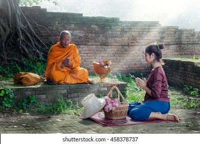 Beautiful asia woman pay-respect monks to achieve happiness.