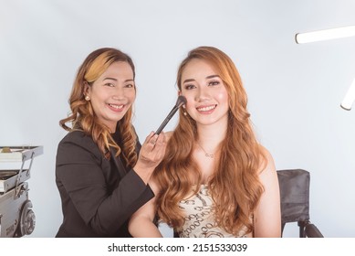 A Beautiful Asian Actress, Celebrity Or Model With Her Makeup Artist Doing Retouching Work At A Studio.