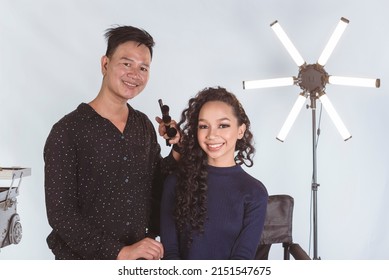 A Beautiful Asian Actress, Celebrity Or Model Posing With Her Personal Makeup Artist Backstage At The Studio.