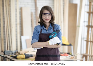 Beautiful Asian Adult Woman Wearing Jeans Clothes Working As A Carpenter In Room At Home. Concept For Wook Work And Hobby For Relaxing And Lifestyle Fo People Who Like Woodworker And Diy Jobs.