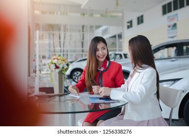 Beautiful Asian American Woman Buying A Car At Dealership