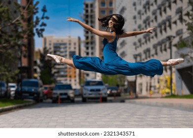 Beautiful Asian ballerina dancing outdoors. Urban landscape. Grand jete.  - Powered by Shutterstock