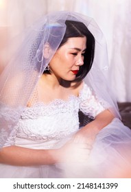 Beautiful Asian Bride Wearing Wedding Dress In Fitting Room