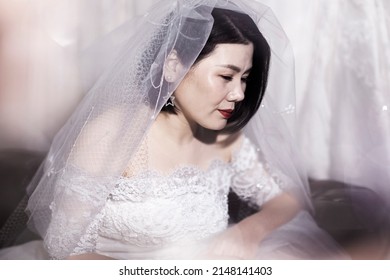 Beautiful Asian Bride Wearing Wedding Dress In Fitting Room