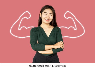  Beautiful Asian Business Woman  With Powerful Hands Showing Muscle And Smiling With Arm Crossed Over Pink Background 