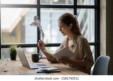 Beautiful Asian business woman sitting and smiling happy to come up with new ideas for work. - Shutterstock ID 2181743511