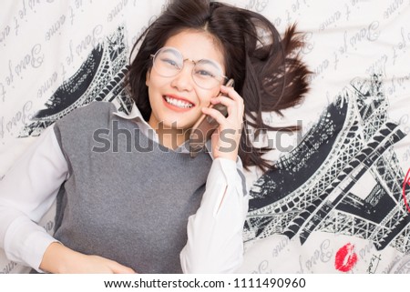 Beautiful asian business women talking on smartphone lying on modern bed, Casual style indoor