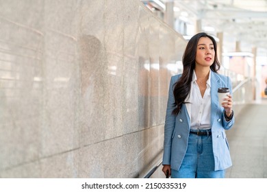 Beautiful Asian Businesswoman Drinking Hot Coffee While Walking City Street To Working In The Morning. Business Woman Holding Coffee Cup Walking In Busy Office Center District In Working Day Rush Hour