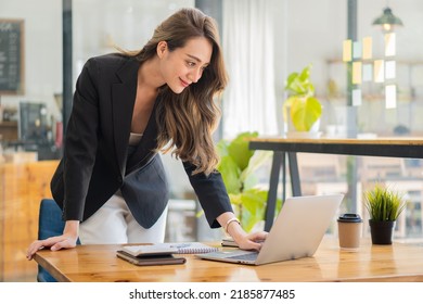 Beautiful Asian Businesswoman, Professional Millennial Woman Or Female Financial Analyst Working On Financial Graphs And Chart Data In The Office.